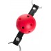 Пластиковый кляп-шар с отверстиями Anonymo на чёрных кожаных ремешках - красный
